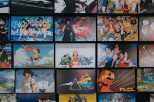 A wall display featuring various anime posters and artwork from series like Sailor Moon One Piece and Pokemon. This curated collection represents the ultimate anime bucket list including must watch mainstream shows that have defined the industry over decades.