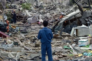 rescue workers searching through destroyed buildings and debris after a powerful earthquake in japan showing the devastating impact of major natural disasters such as the great east japan earthquake and other seismic events across the japanese archipelago.