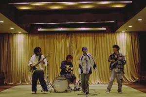 japanese band performing live with guitars drums and vocals representing modern japanese music culture including jpop rock and alternative music scenes.