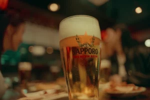 glass of sapporo premium beer served in japanese izakaya representing japanese beer culture and social drinking tradition in japan.