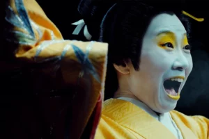 kabuki theatre actor wearing traditional makeup and costume performing dramatic expression representing classic japanese cultural performing arts.