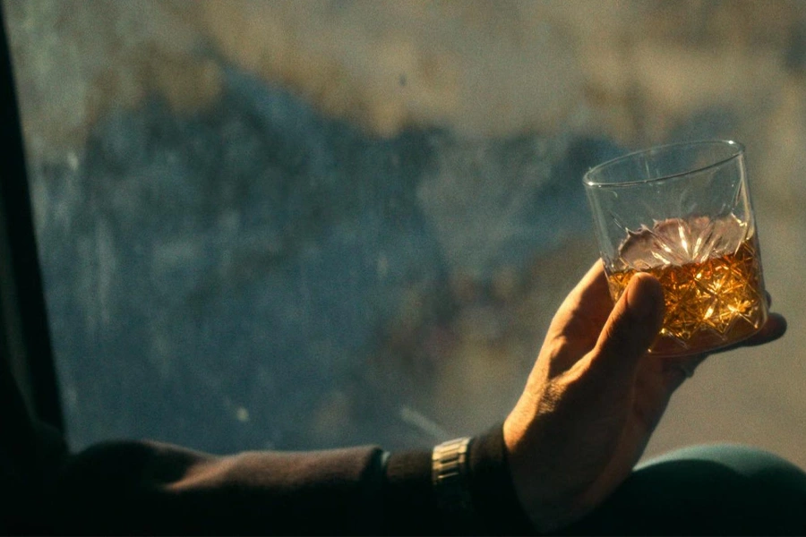 drinking Japanese whiskey with a a Japanese whiskey glass in hand