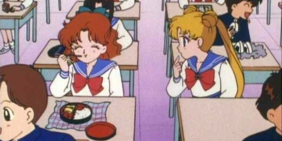 Sailor Moon talking to her classmate in a classroom