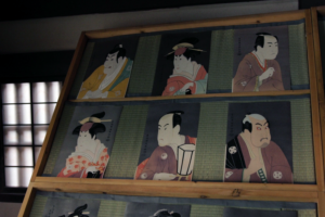 traditional ukiyoe woodblock print portraits of kabuki actors displayed in a japanese interior representing edo period art and the floating world culture.