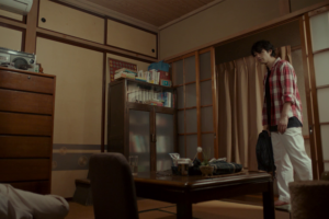 foreign resident viewing traditional japanese apartment interior while searching for rental housing through real estate agency in japan.