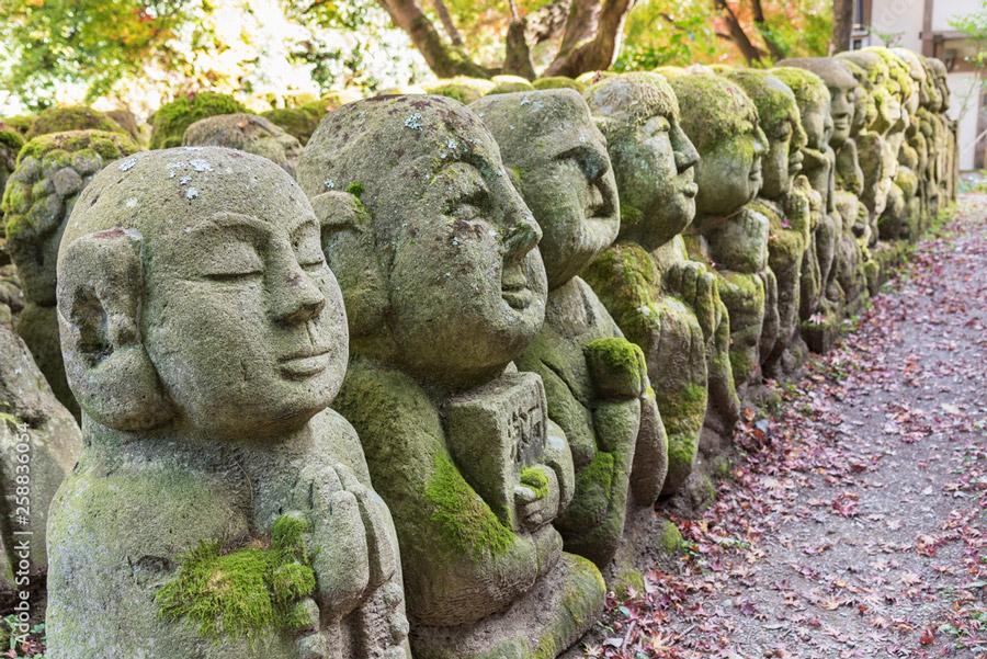 carved stone guardians at Arashiyama mountain