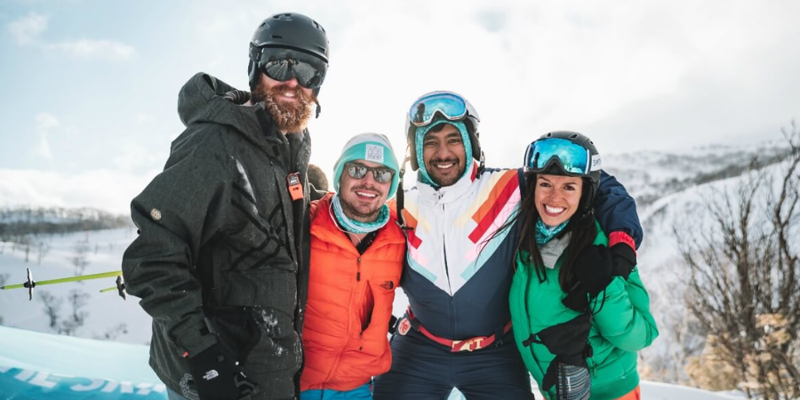 4 people in ski gear posing for the camera