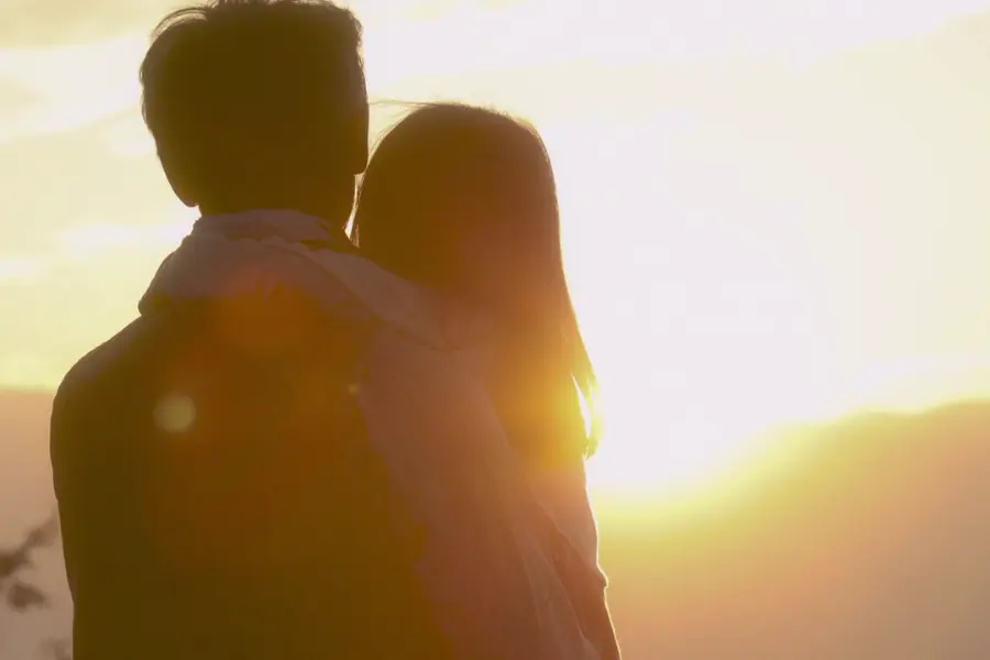 a japanese couple enjoying a sunset at dusk