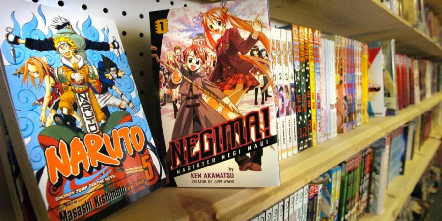 A shelf of Japanese manga books, featuring Naruto and Negima! manga