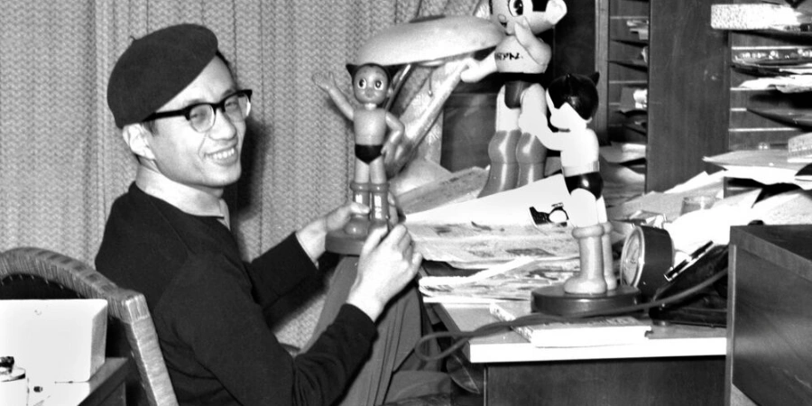 Osamu Tezuka with Astro Boy figurines
