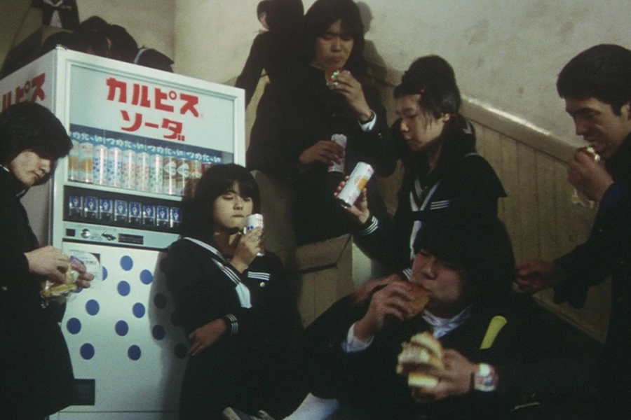 Japanese students drinking soda by the vending machine