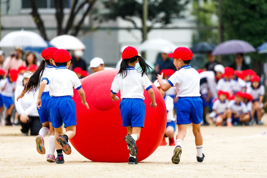Japanese school kids playing on sports day