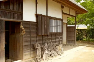 traditional wooden akiya vacant house in rural japan showing aging population impact and abandoned homes in countryside village setting.