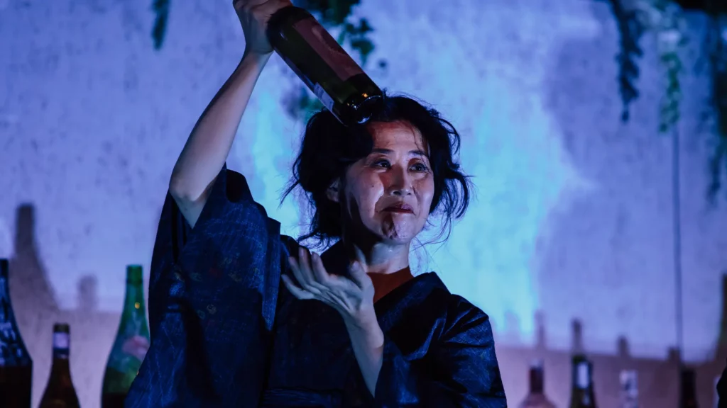 An actress in Good-bye holding a bottle of alcohol An actress in Good-bye holding a bottle of alcohol