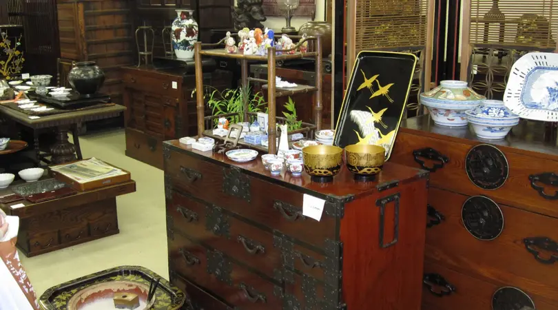 A room filled with antique furniture, tableware, and ceramics