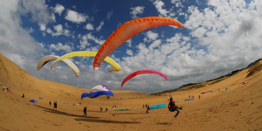 People paragliding and sand dunes adventure in Tottori
