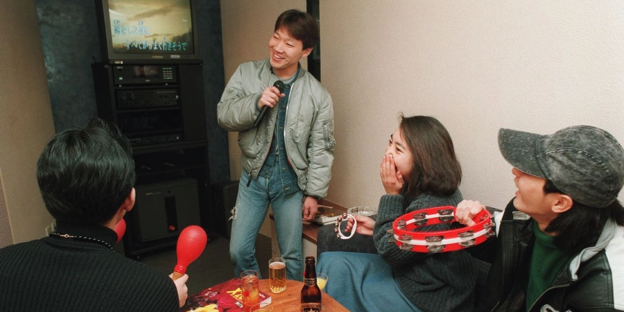 Four people doing karaoke