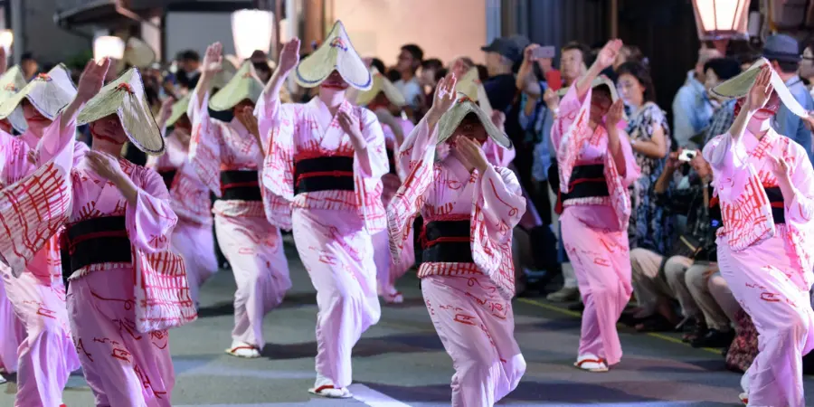 dancers in pink kimonos on the street as part of Owara Kaze no Bon Festival (Toyama)
