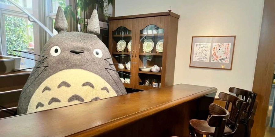 Totoro standing behind the bar