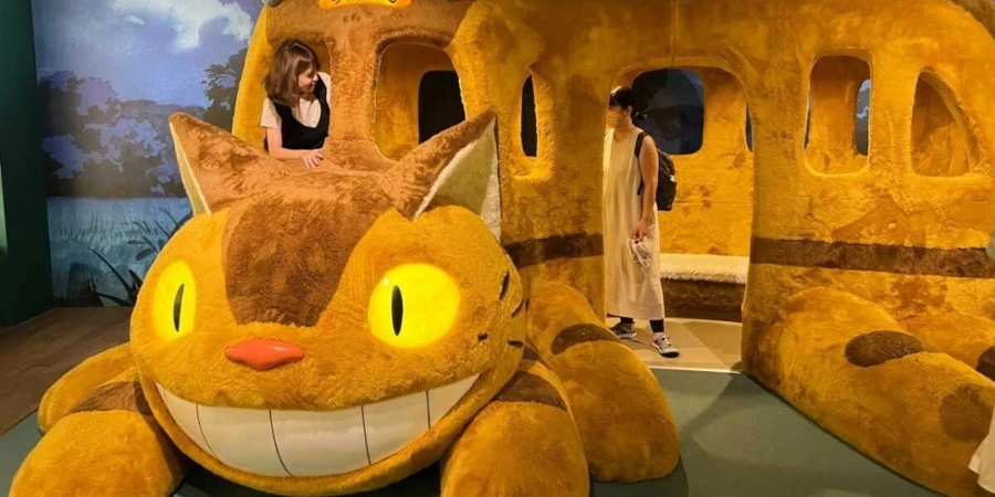 Two women exploring the "Cat (Neko) Bus"
