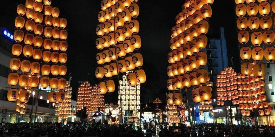 A Japanese night market with several lanterns hanging