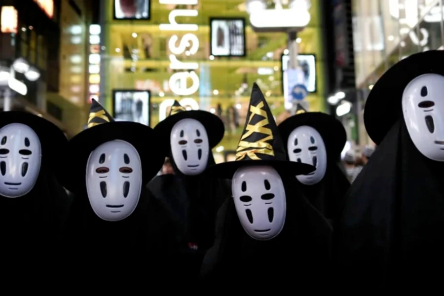A group dressed as a bunch of No-Face for Halloween