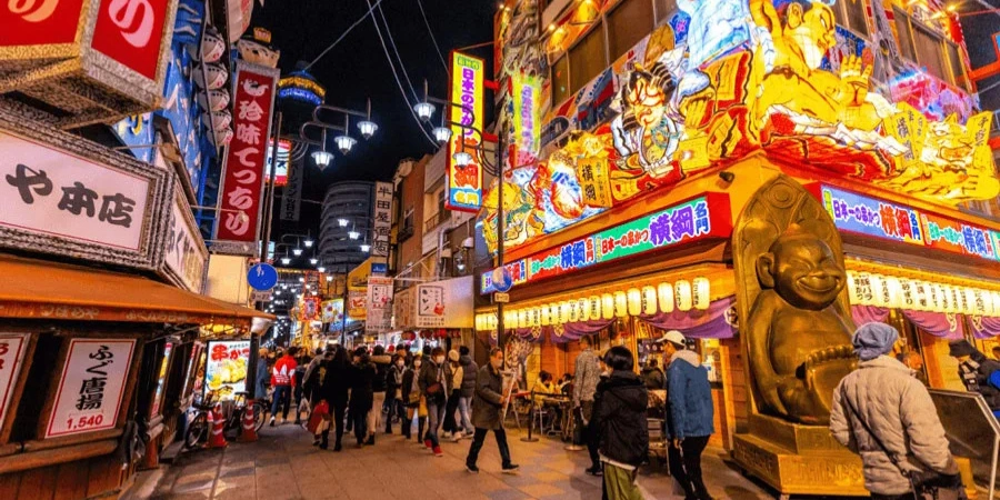 Bright neon lights and a lot of people walking