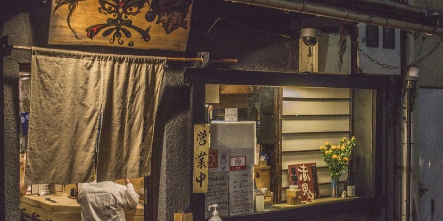 A person eating inside a restaurant at night