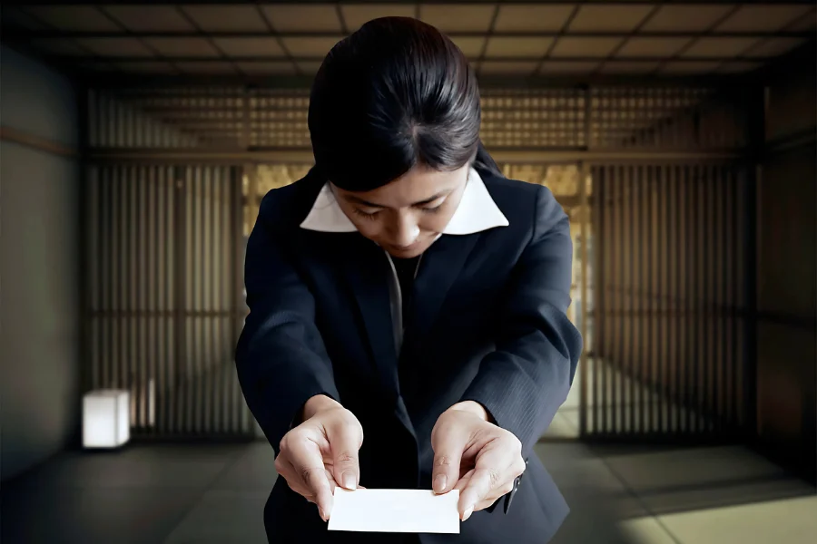 lady handing out a business card with both hands