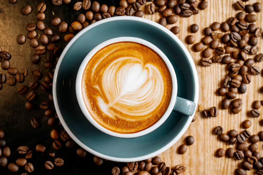 A cup of coffee with coffee art on top