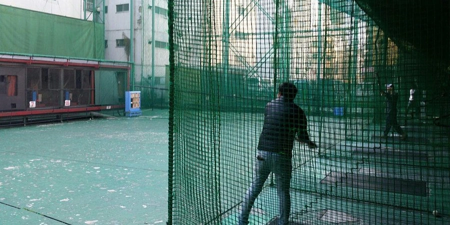 A man practicing his batting swinging skills