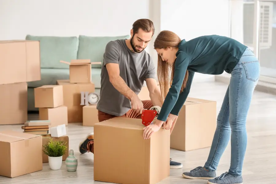 A couple packing their things for moving