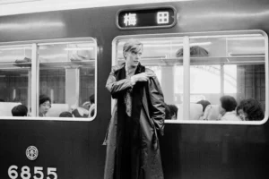 David Bowie beside a train in Japan