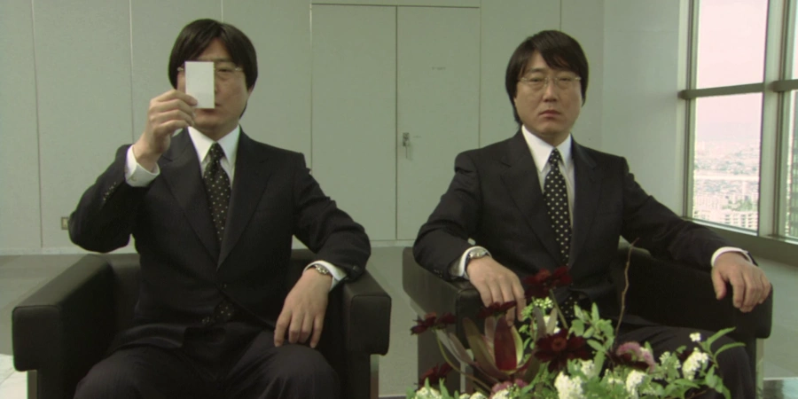 two japanese salarymen at the office sitting side by side