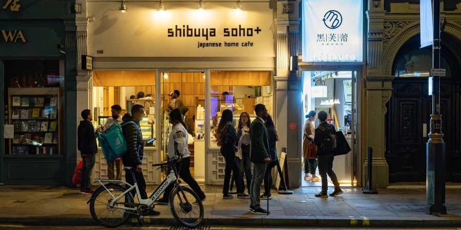 exterior of Shibuya Soho at night with people milling about in front of the cafe