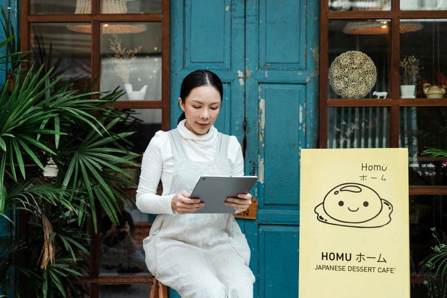 Japanese Business Woman reading from her tablet.