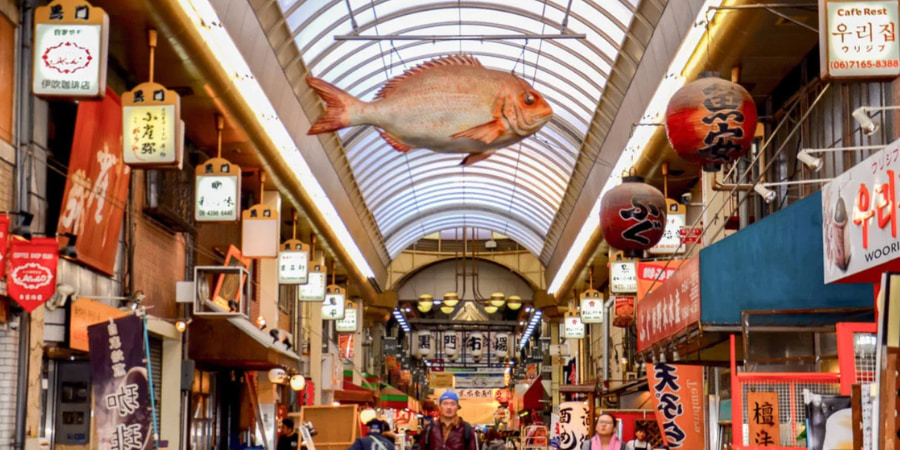 Giant fish display and shops lining Kuromon Market