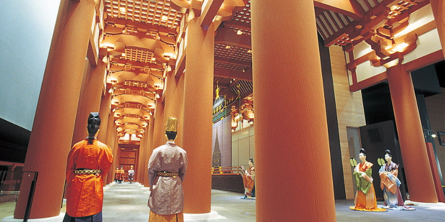 Statues in a bright pavilion depicting Japan in the past