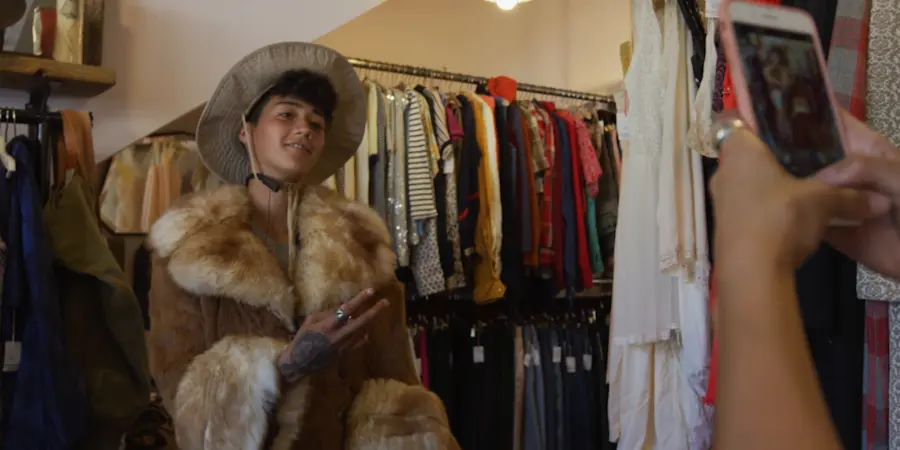 Trying on vintage items at a second hand clothing store