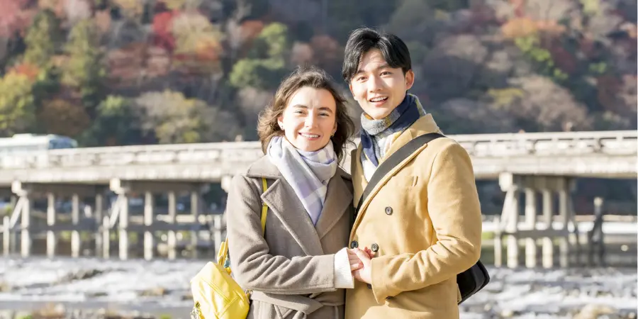 Couple hugging each other while wearing coats and scarves