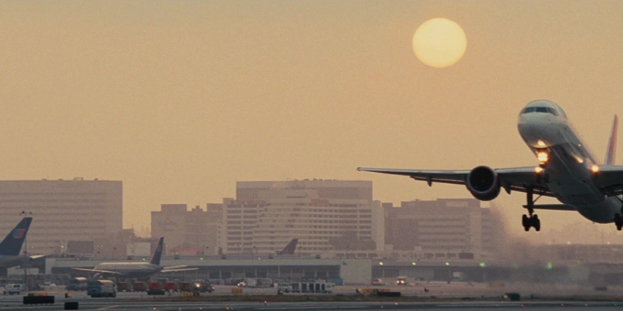 Airplane taking of in front of a sunset