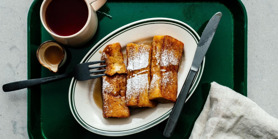 French toast on a green tray with coffee on the side