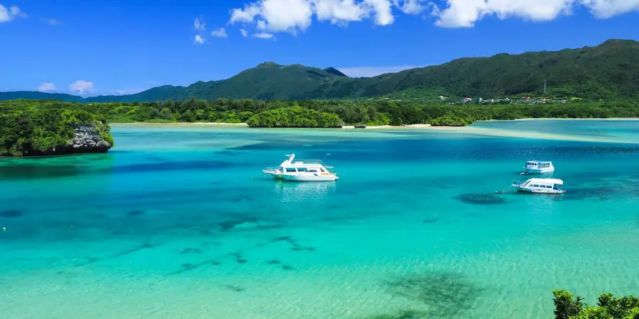 Yachts on the ocean overlooking the mountains in Ishigaki Island