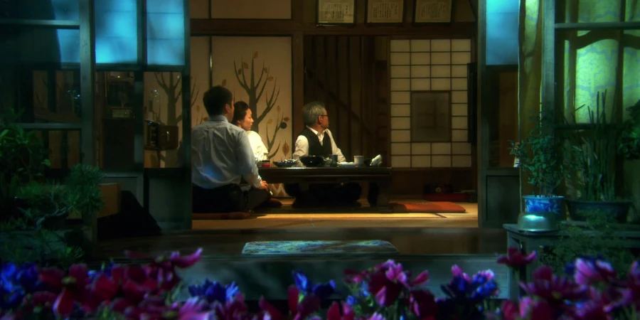 Guests inside a ryokan that has a view of a garden and flowers