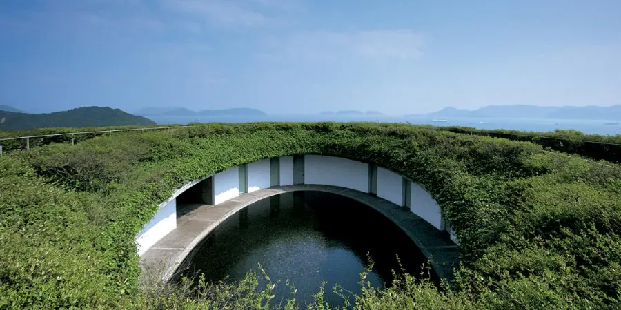 Spheric structure floating above water and covered by greenery