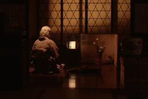 The owner kneeling inside the ryokan