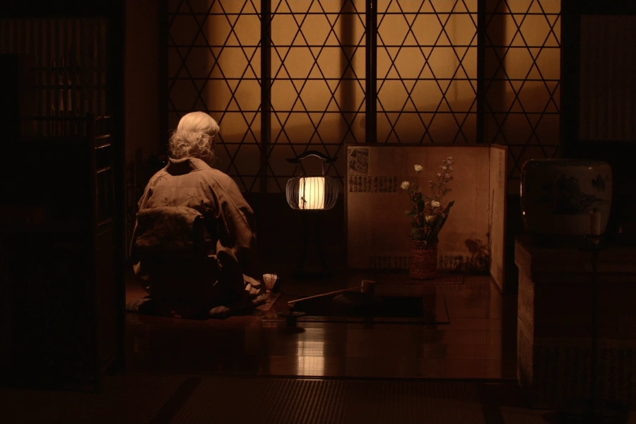 The owner kneeling inside the ryokan