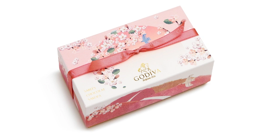 A box of GODIVA sakura chocolates. The package is white and pink.