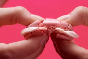 gooey and crispy Sakura macaron being broken apart