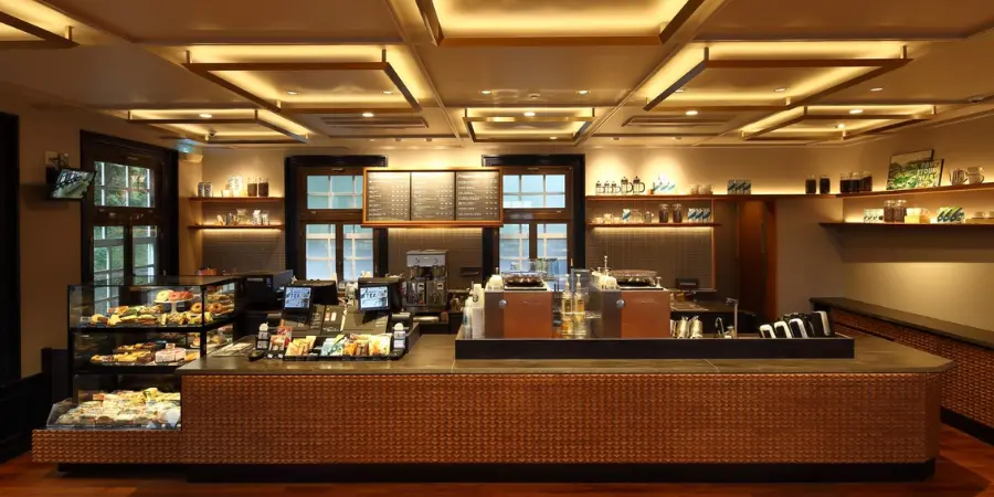 Interior of Starbucks Senganen with a paneled ceiling and glass-inspired bar counter